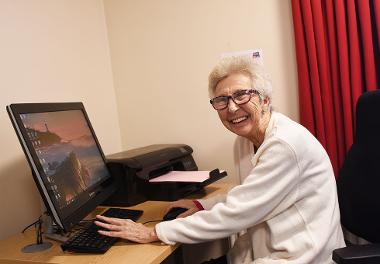 Resident at Bishop Ramsay Court using the computer facilities.